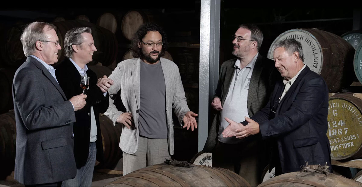 Group of men in discussion in a whisky distillery